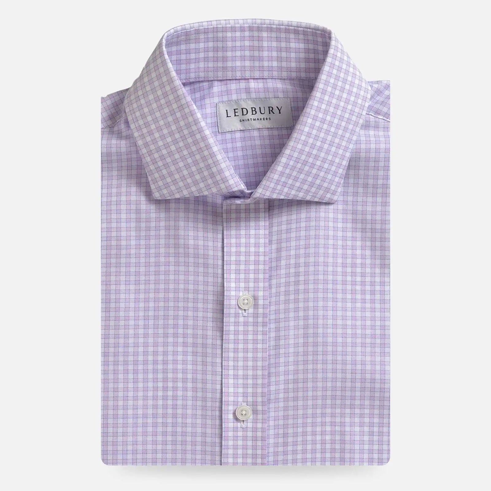 A folded light purple and white checkered dress shirt by Ledbury, shown against a clean off-white background.