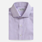 A folded light purple and white checkered dress shirt by Ledbury, shown against a clean off-white background.