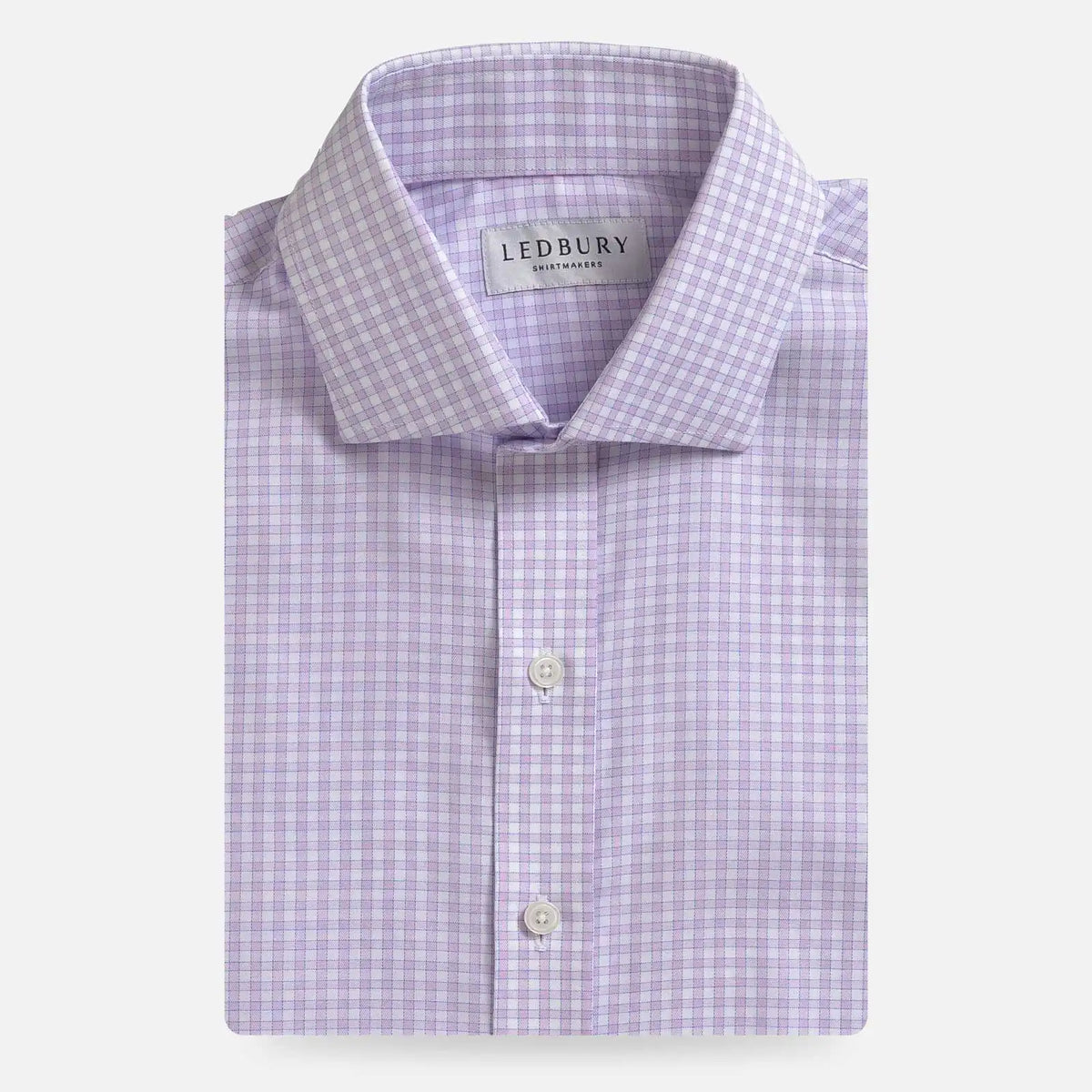 A folded light purple and white checkered dress shirt by Ledbury, shown against a clean off-white background.