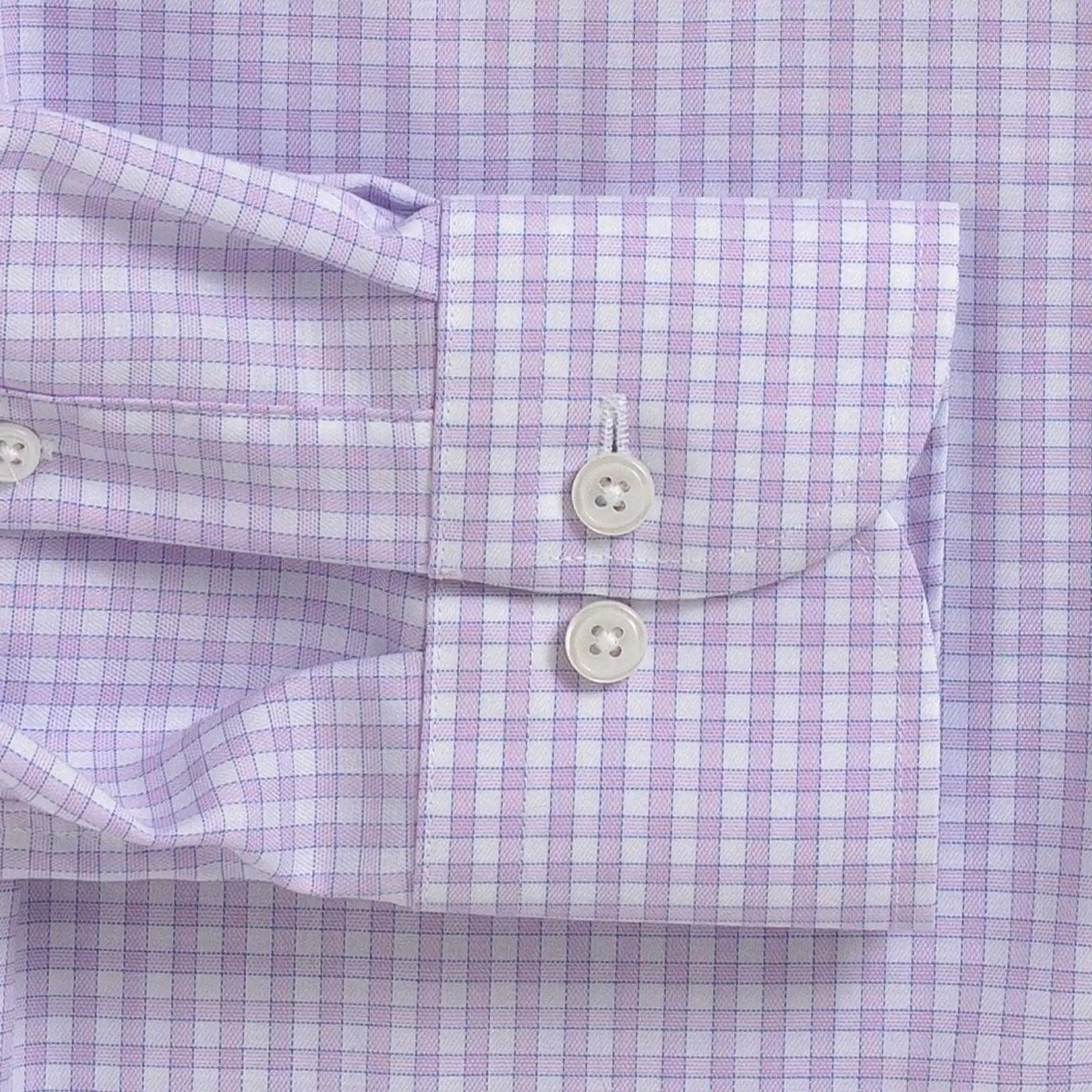 Close-up of a lavender and white gingham checkered dress shirt cuff with two white buttons.