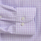Close-up of a lavender and white gingham checkered dress shirt cuff with two white buttons.