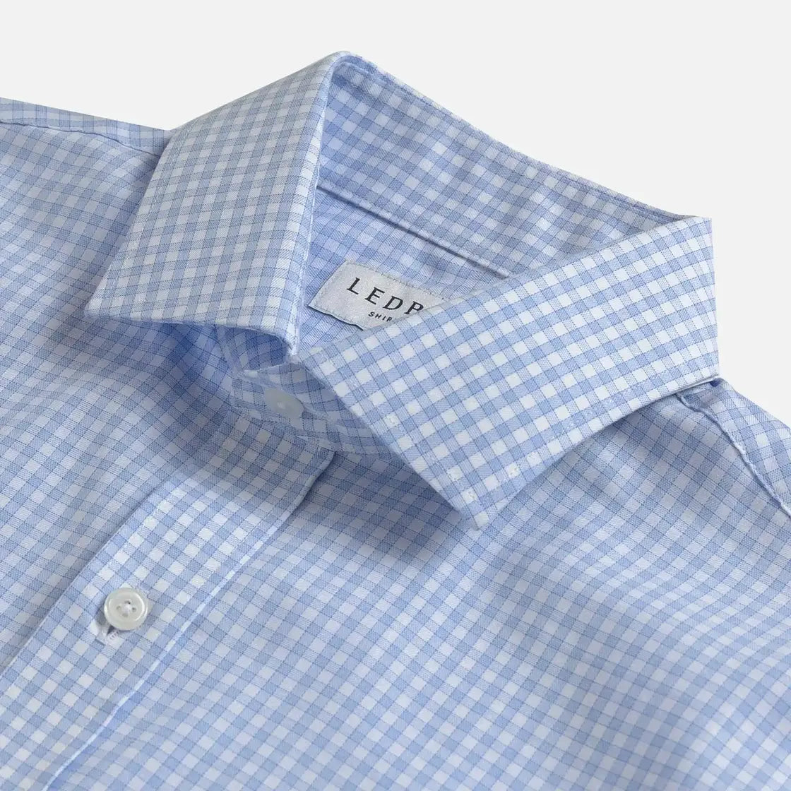Close-up of a light blue and white gingham dress shirt collar with a visible Ledbury neck label.