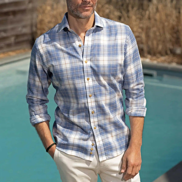 Man wearing a blue and white checkered shirt by a pool
