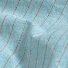 Close-up of sea green stripe fabric texture on the Barretto cotton-linen shirt