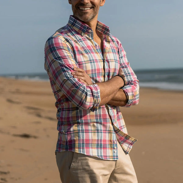 Man wearing the Ledbury Pink Leclair Madras Plaid shirt standing on the beach