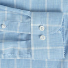 Sleeve detail of an Italian Albini light blue and white checkered button down shirt