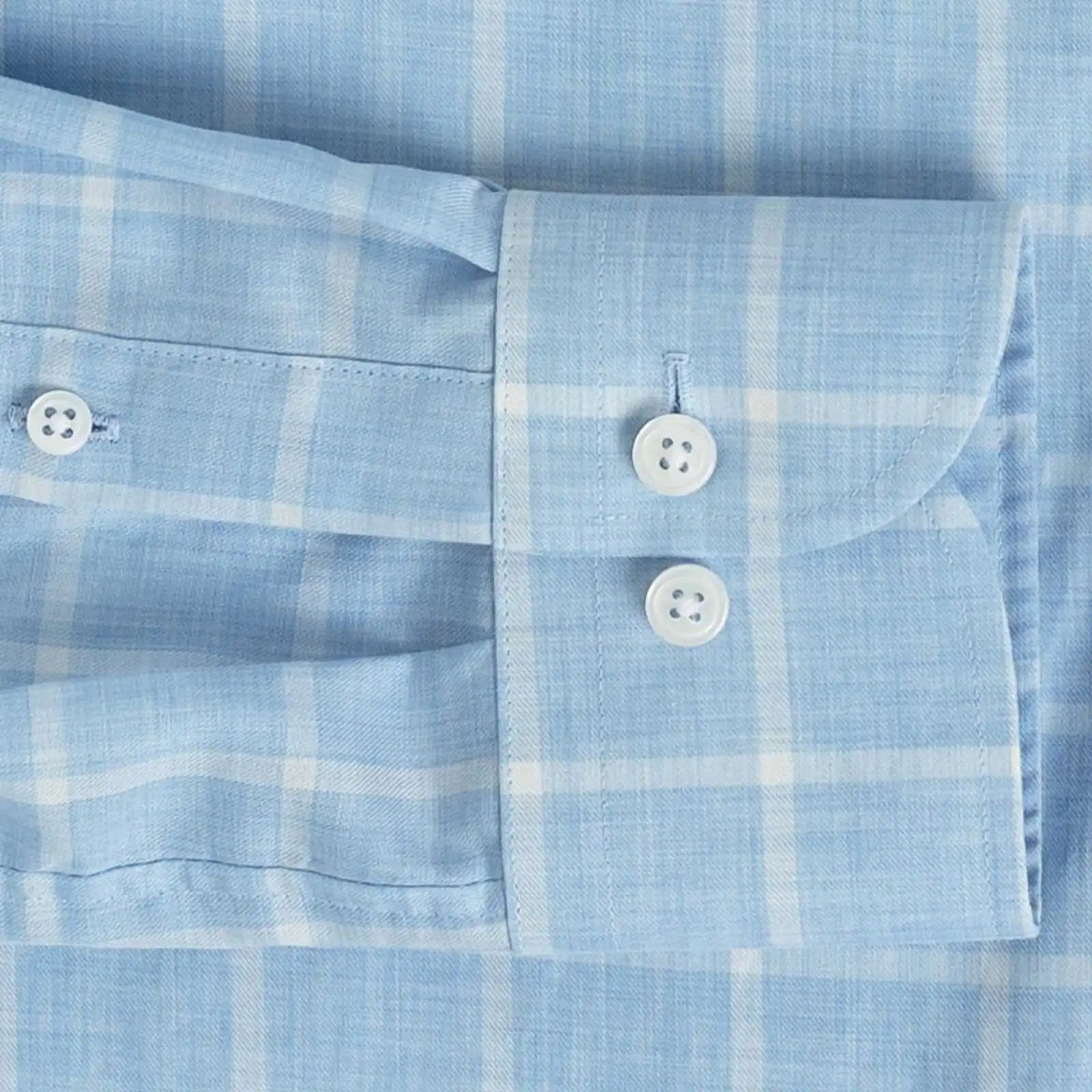 Sleeve detail of an Italian Albini light blue and white checkered button down shirt