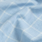 Close-up fabric detail of the blue Albini Pritchard Italian checkered dress shirt