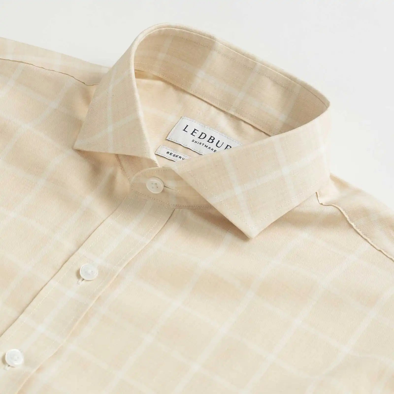 Collar detail of an Italian Albini cream and white checkered button down shirt