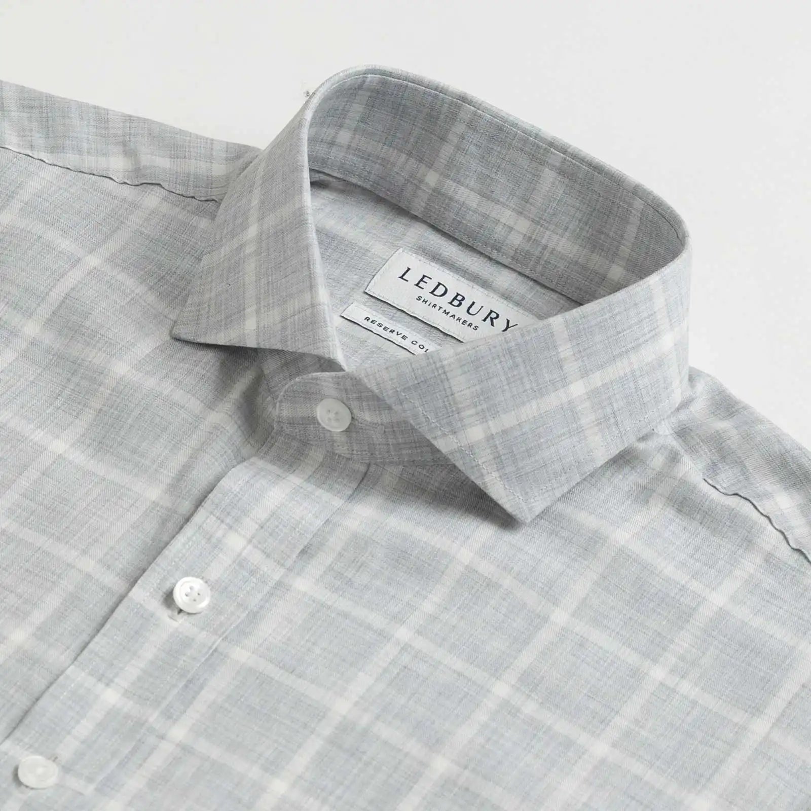 Collar detail of an Italian Albini light grey and white checkered button down shirt