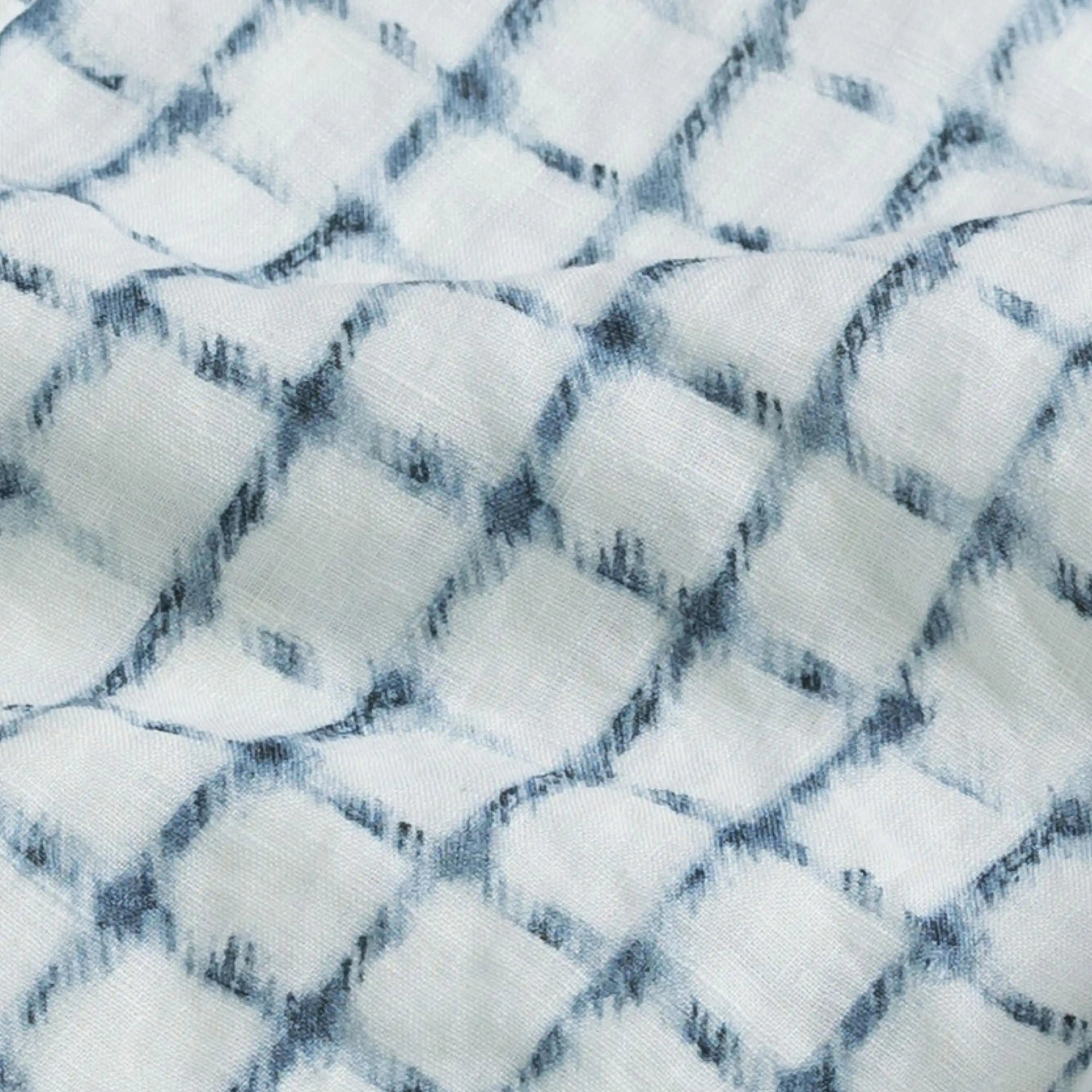 Close-up of a textured Italian linen fabric with a check pattern in white and blue.