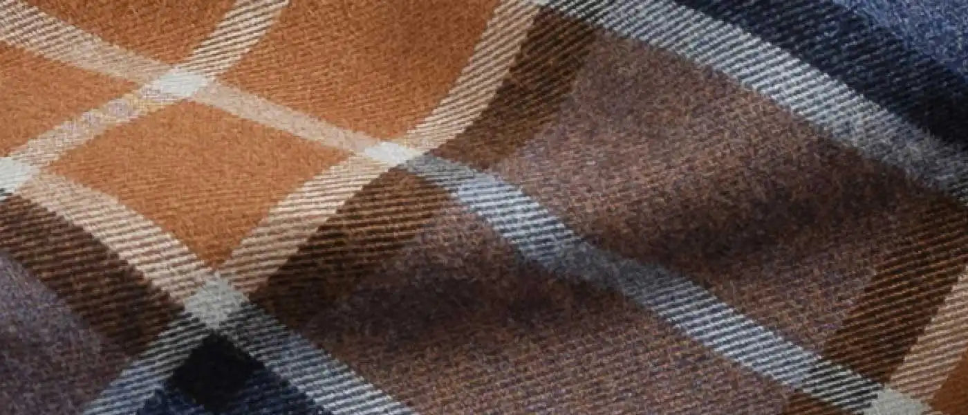 orange and navy plaid flannel fabric close up