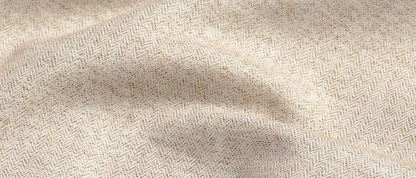 Close-up of beige fabric with a subtle herringbone pattern