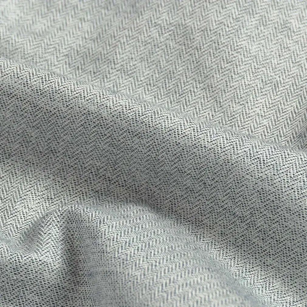 Close-up of gray fabric with a subtle herringbone pattern