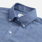Close-up of a blue brushed oxford shirt with collar and buttons 