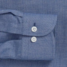 Close-up of a blue brushed oxford button down shirt sleeve 