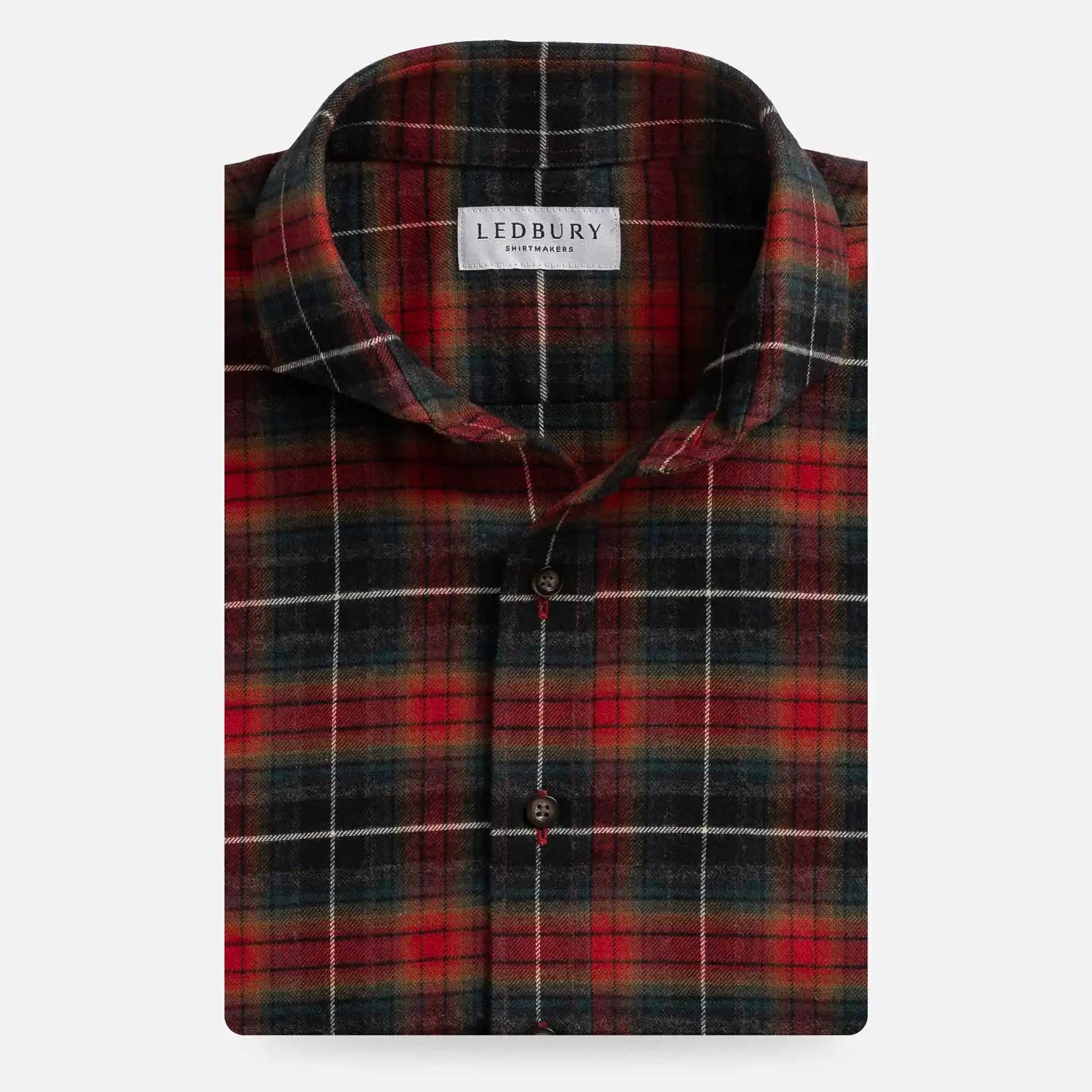 A folded long-sleeve plaid shirt by Ledbury, featuring a red, green, and black tartan pattern with thin white accent lines, on a light gray background.