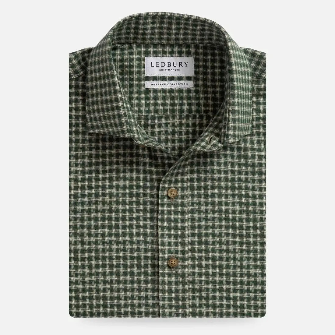 A folded men's dress shirt by Ledbury, featuring a green and white gingham check pattern with brown buttons, set against a plain light gray background.