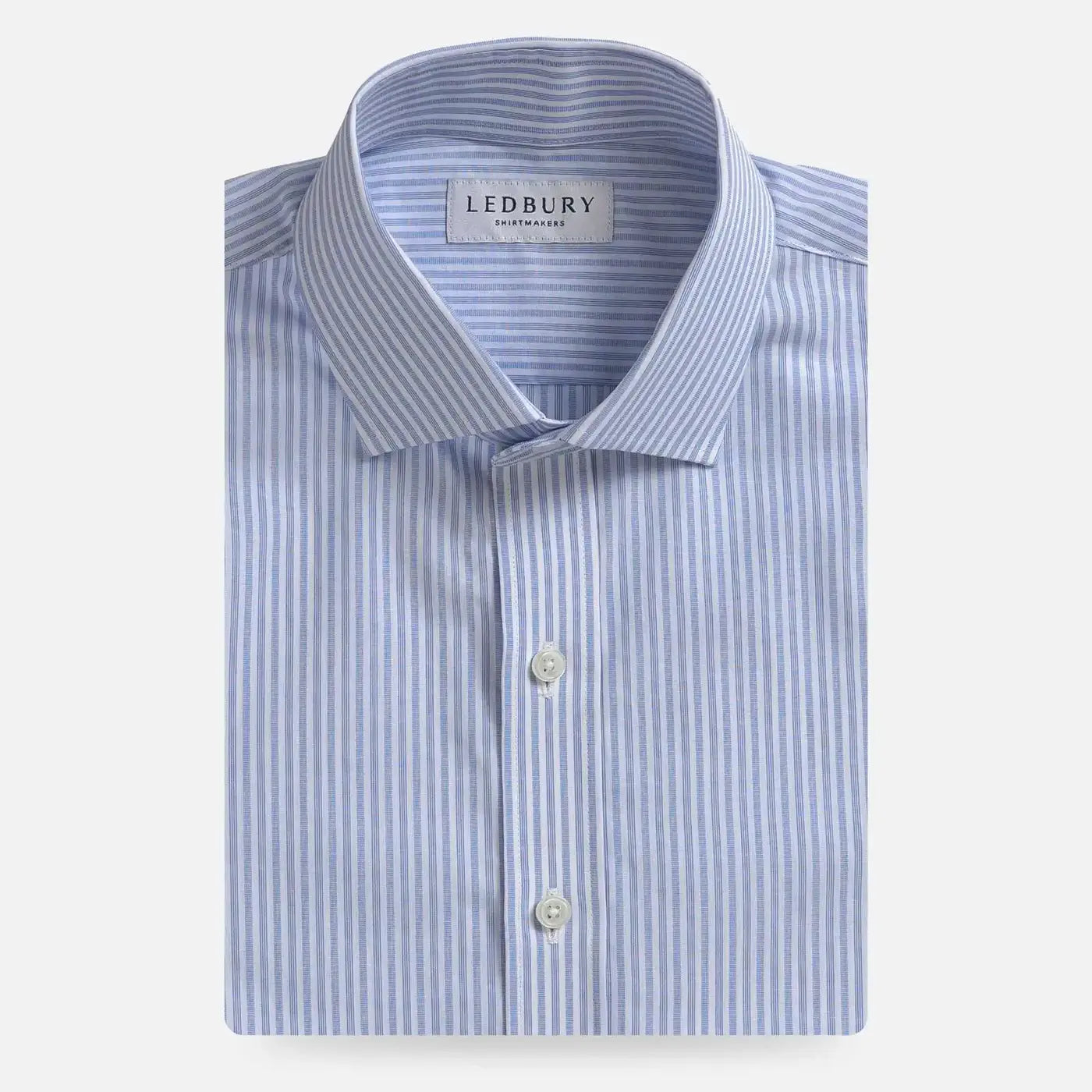 A folded light blue and white striped dress shirt by Ledbury, featuring a classic collar, white buttons, and a clean white background.