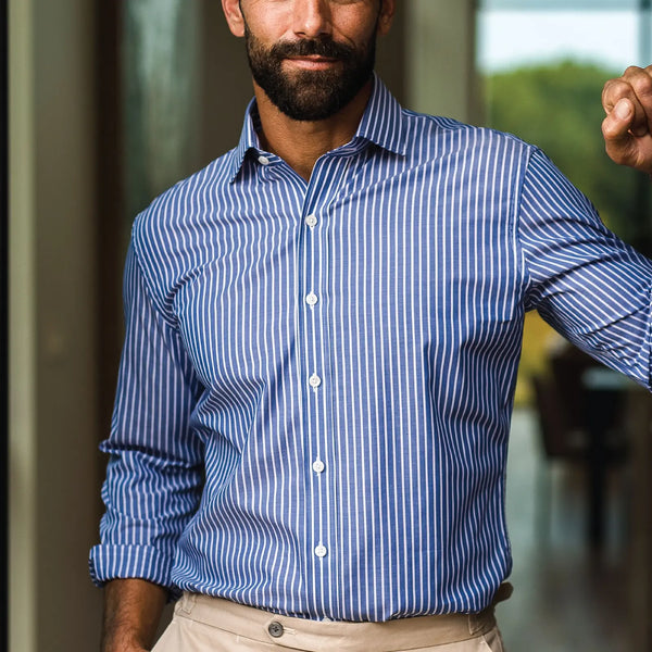 Model wearing the blue and white striped navy and white Henderson dress shirt by Ledbury.