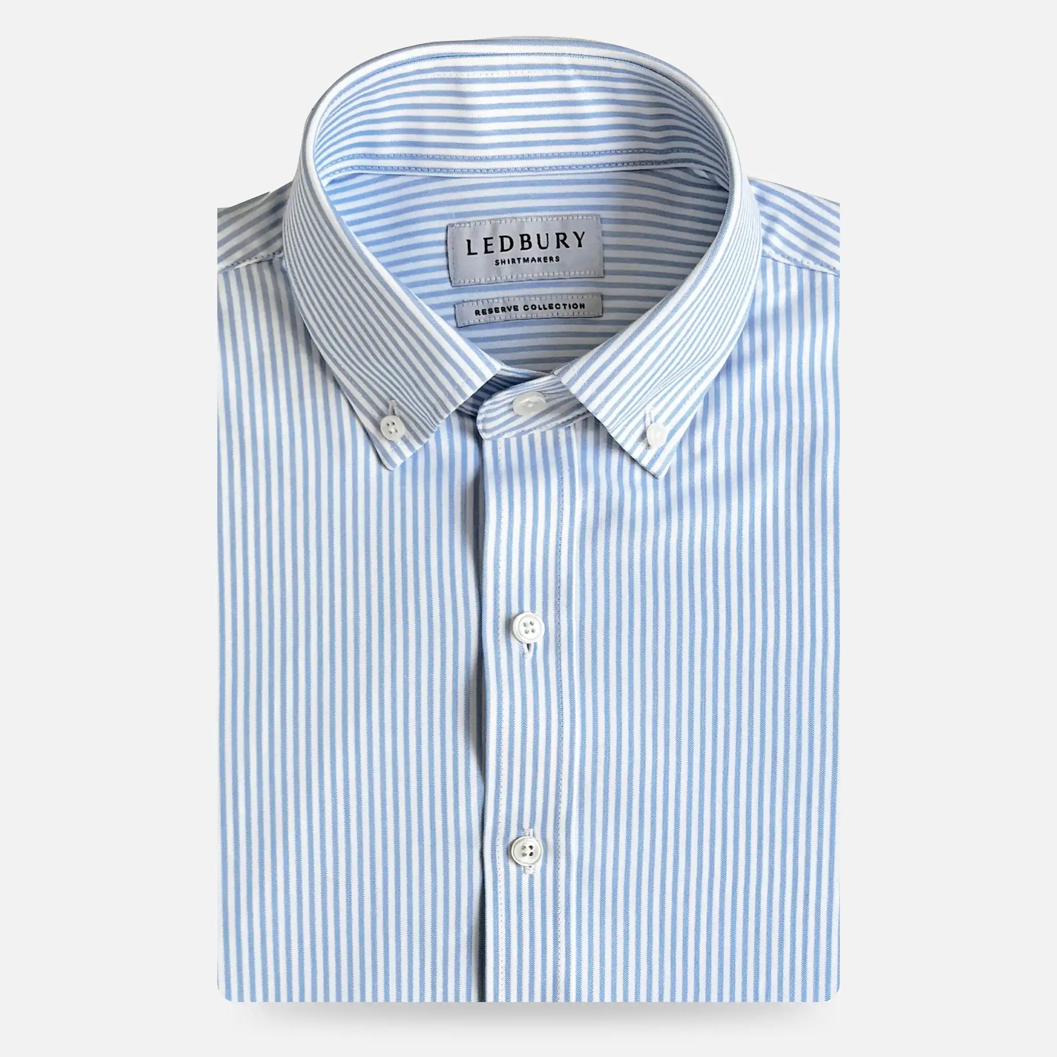 A folded light blue and white striped button-down dress shirt by Ledbury, shown on a clean white background.
