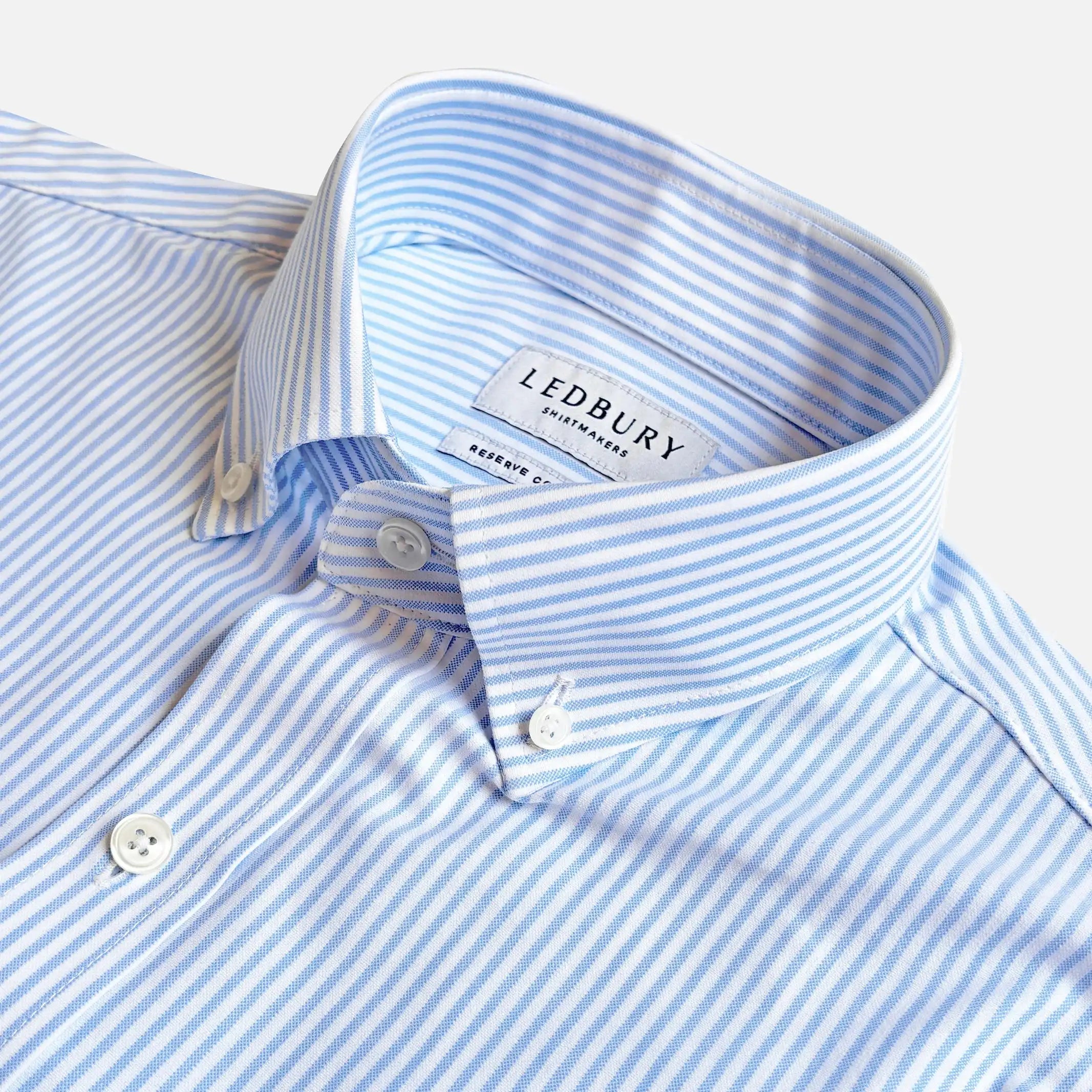 Close-up of a light blue and white striped button-down shirt collar with the LEDBURY brand label visible inside the neck.