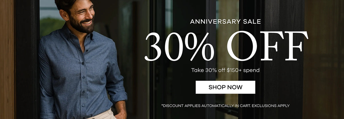 Promotional banner for an anniversary sale featuring a smiling man in a blue button-down shirt standing next to large white text that reads 'ANNIVERSARY SALE 30% OFF' with a 'SHOP NOW' button.