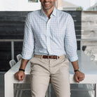 Man wearing the light green Ellis checkered shirt and beige pants, standing in an outdoor setting.