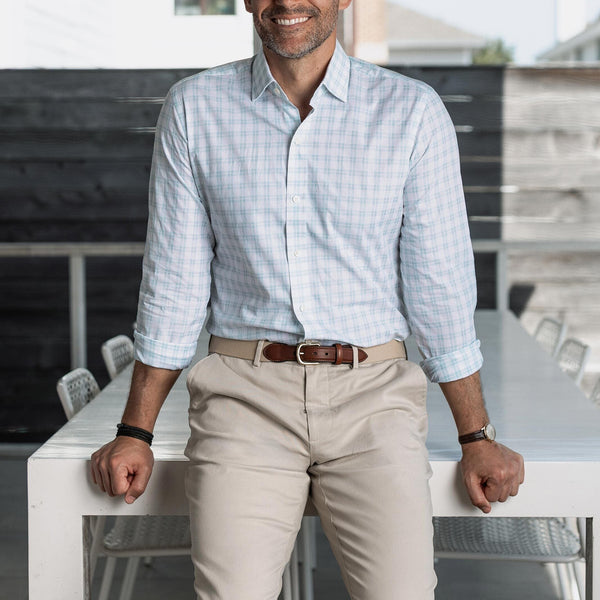 Man wearing the light green Ellis checkered shirt and beige pants, standing in an outdoor setting.