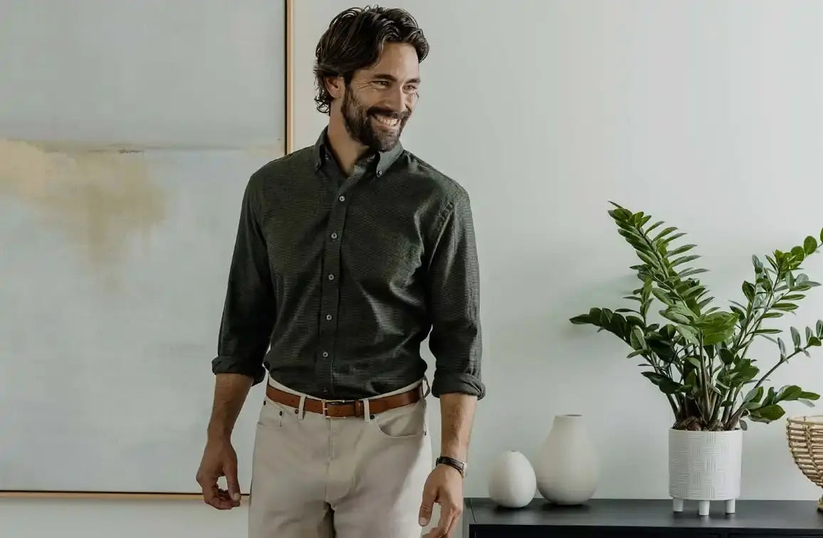 Man wearing a green houndstooth shirt in an indoor setting