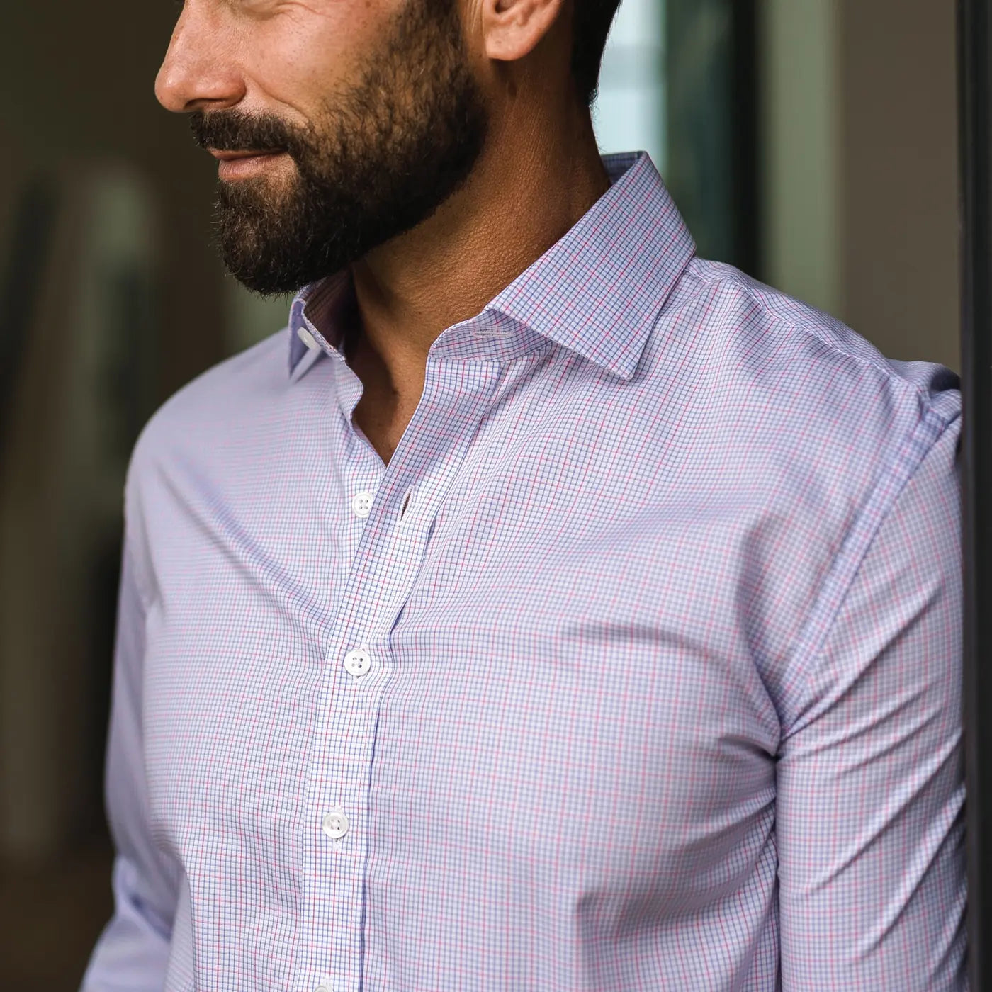 Closeup of the collar of a pink windowpane check dress shirt with a small scale pattern by Ledbury. 