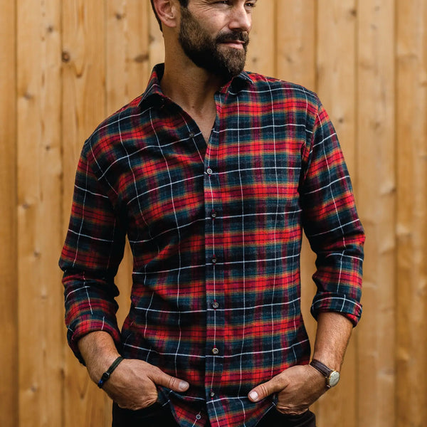 Man wearing a black, grey and red plaid flannel shirt by Ledbury