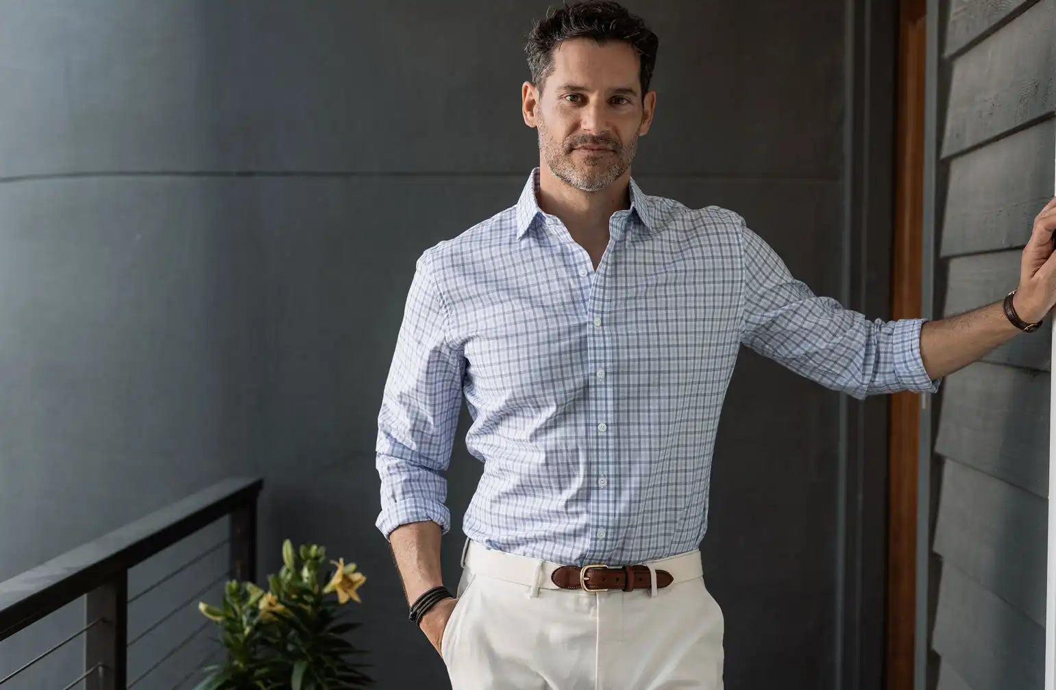 Model wearing a men's navy blue and light blue check shirt by Ledbury