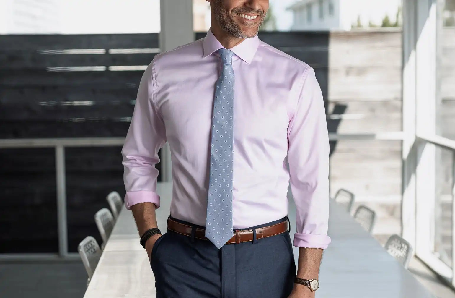 Model wearing a pink Ledbury non iron dress shirt with a light blue tie