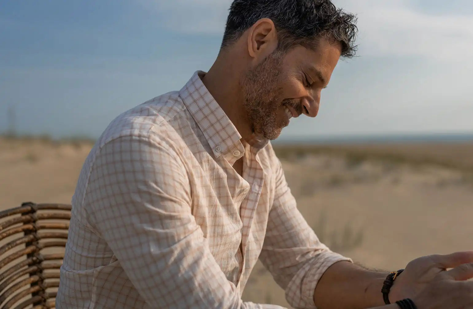 Man wearing a Ledbury button down shirt in a pale peach check 