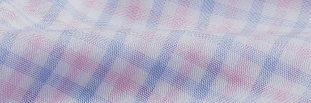 Closeup of the fabric of a blue and pink men's check button down dress shirt
