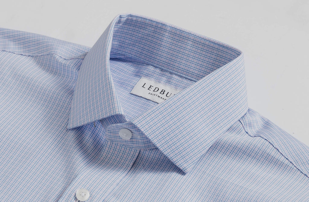 Closeup of the collar of a men's small scale blue and pink tattersall dress shirt 