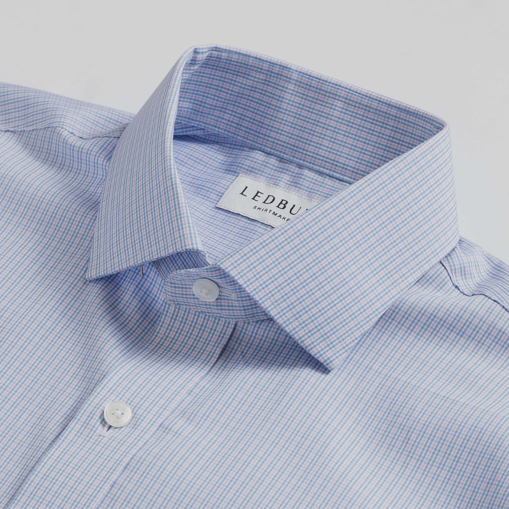 Closeup of the collar of a men's small scale blue and pink tattersall dress shirt