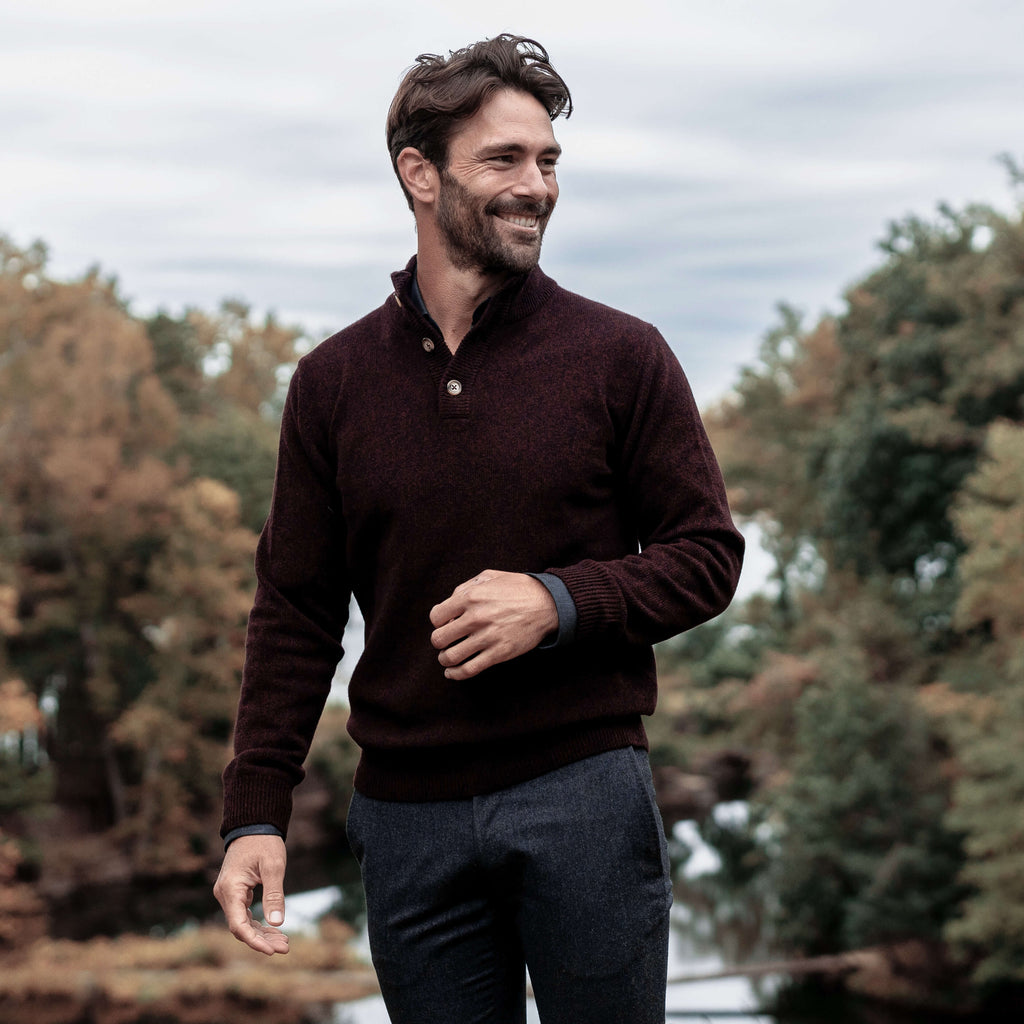 Man outdoors wearing the burgundy brewer sweater.