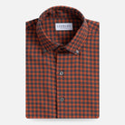 A folded men's button-down shirt by Ledbury, featuring a burnt orange and dark grey gingham check pattern, displayed on a clean light gray background.