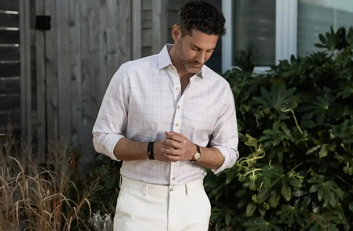 Model wearing a tan checked button down shirt from Ledbury